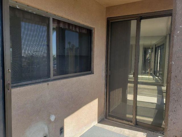 a room with pool table and windows