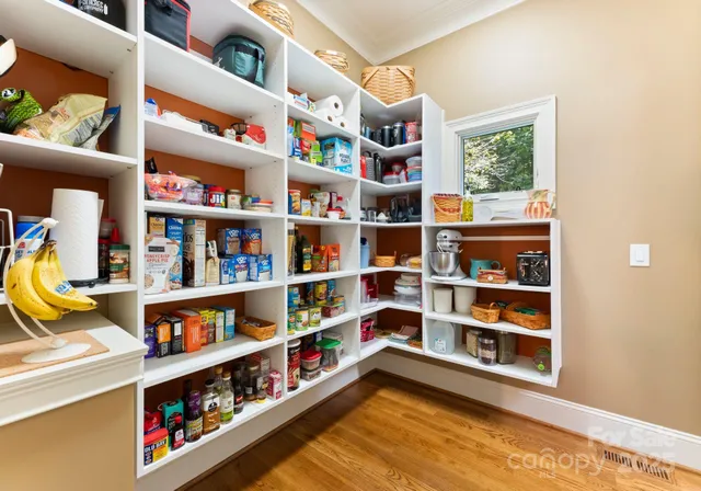 a room with lots of books and a large window