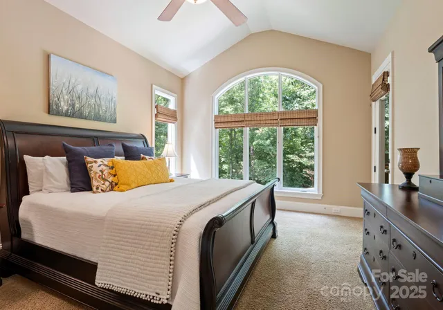 a bed sitting in a bedroom next to a window