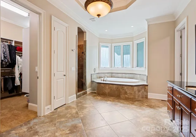 a view of bathroom with bathtub and wooden floor