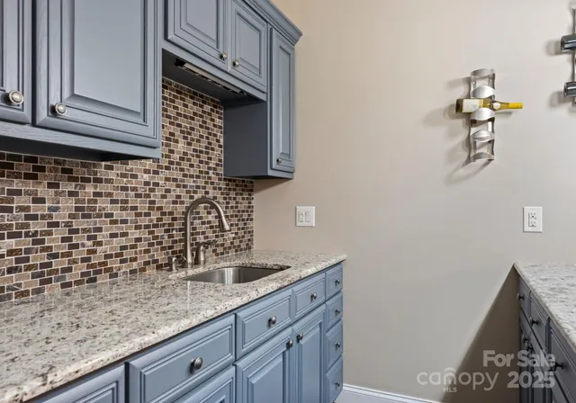 a kitchen with a sink and cabinets