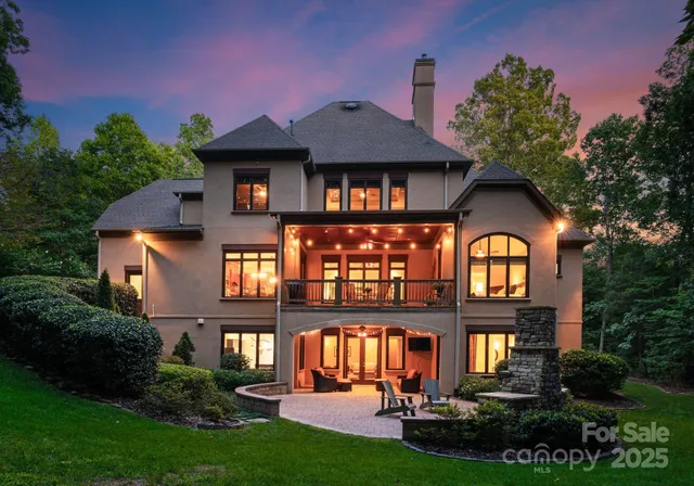 a front view of a house with yard and green space