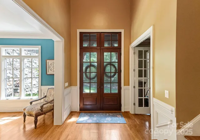 a view of an entryway with wooden floor and windows