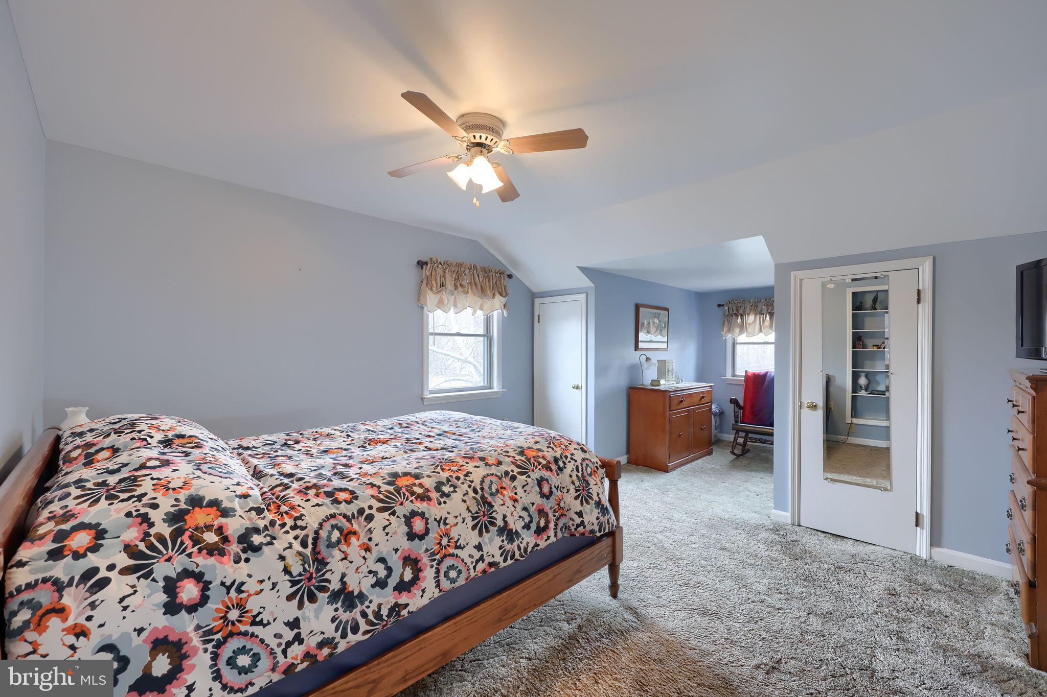 291 Bushong Road Leola, PA 17540 - Photo 31 of 81 a bedroom with a large bed and a chandelier