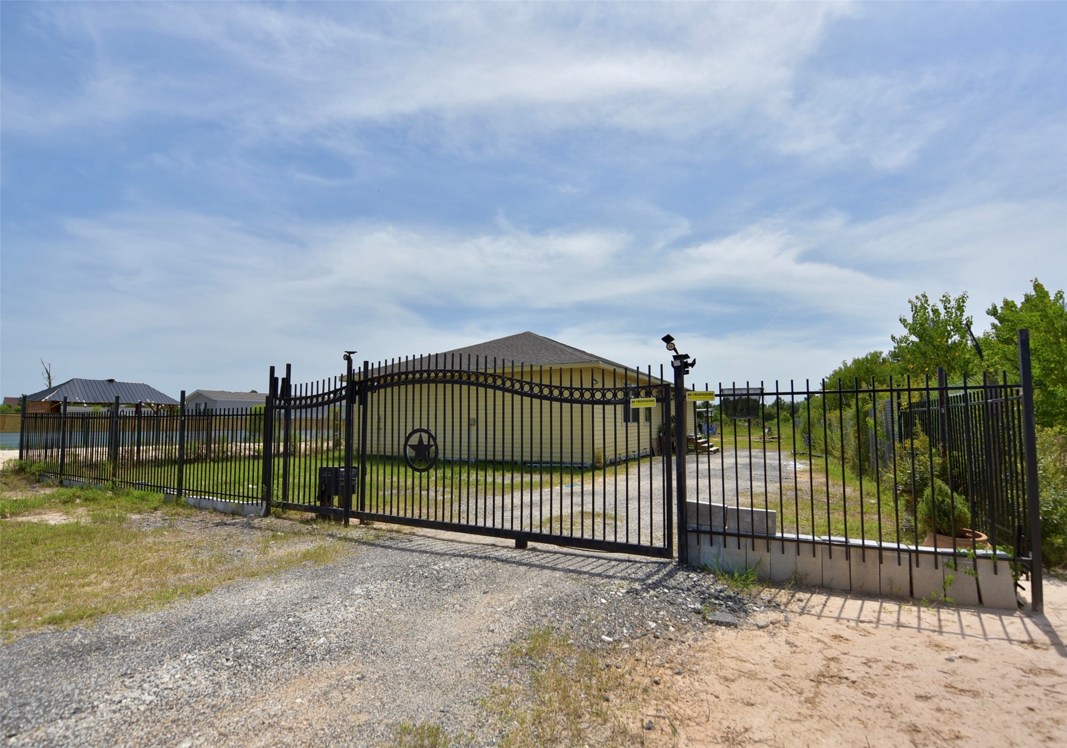 Secure and welcoming, the home's entrance features an elegant steel gate.