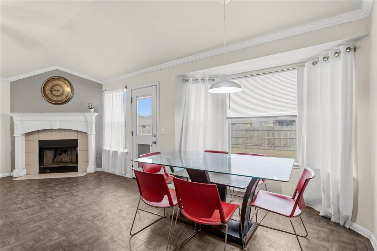 281 Leonardo Kyle, TX 78640 - Photo 12 of 38 a living room with furniture a fireplace and a table