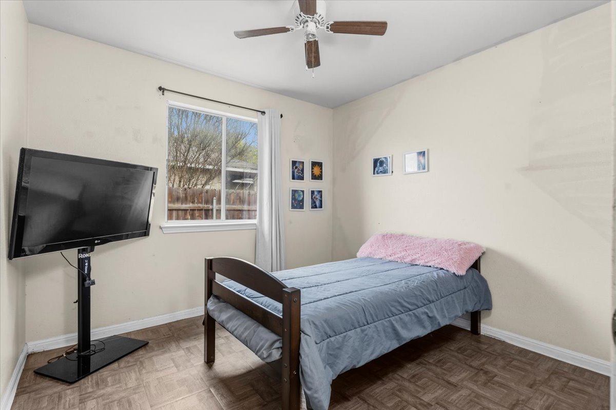 281 Leonardo Kyle, TX 78640 - Photo 19 of 38 a bedroom with a bed and a flat screen tv