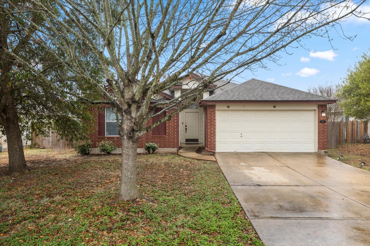 281 Leonardo Kyle, TX 78640 - Photo 2 of 38 a front view of a house with a yard and garage