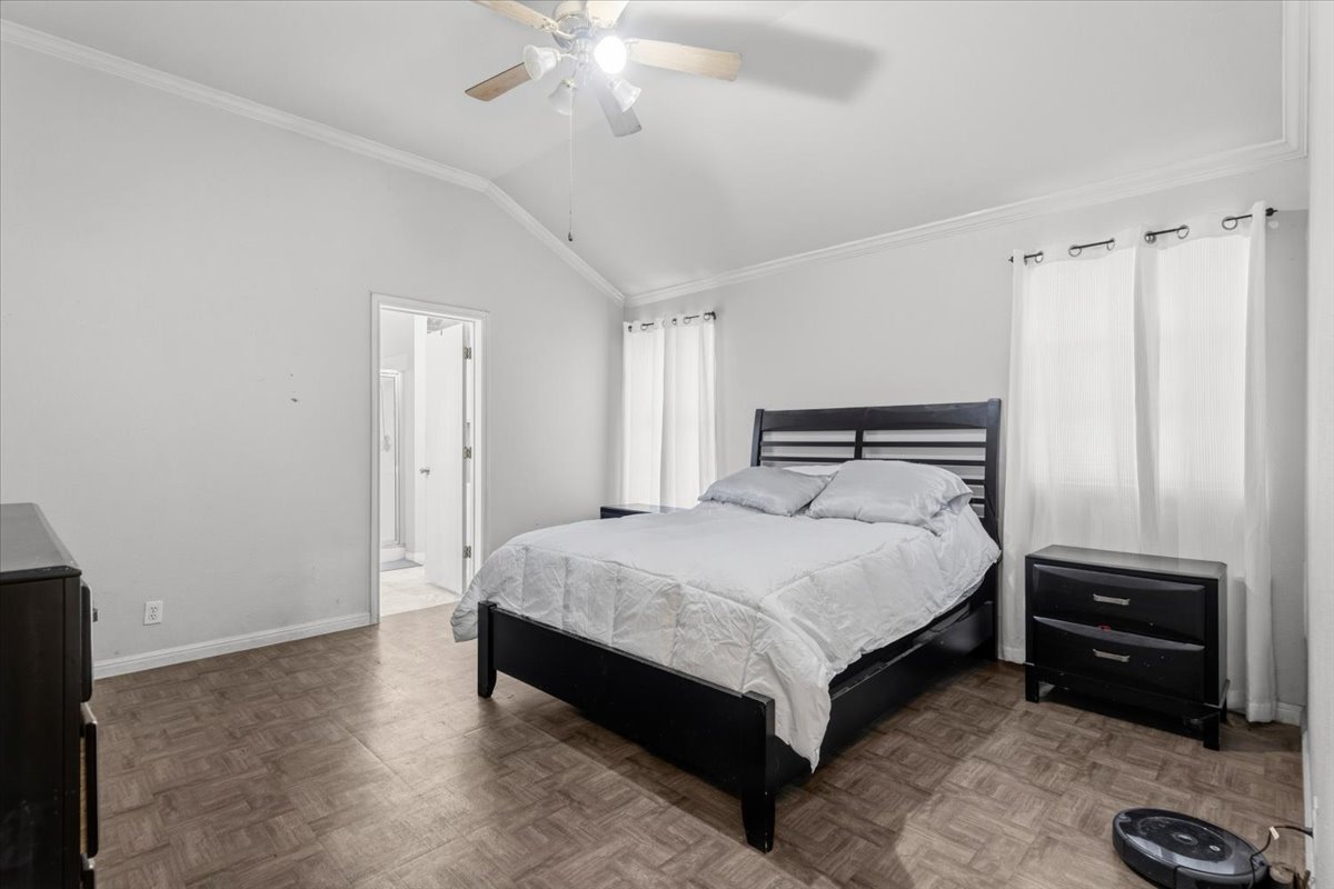281 Leonardo Kyle, TX 78640 - Photo 22 of 38 a bedroom with a bed and a chandelier