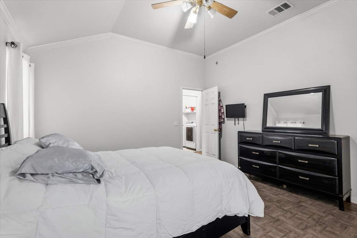 281 Leonardo Kyle, TX 78640 - Photo 24 of 38 a bedroom with a bed and a flat tv screen on a dresser