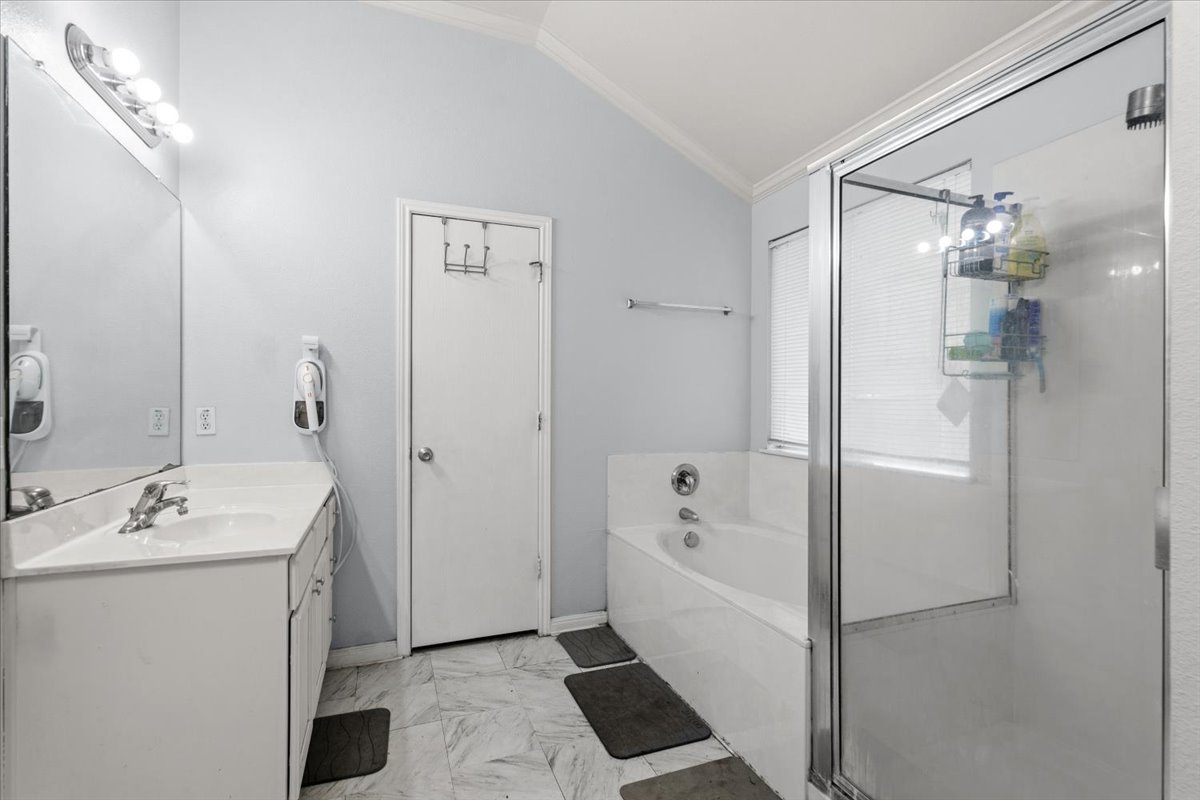 281 Leonardo Kyle, TX 78640 - Photo 27 of 38 a bathroom with a sink a mirror and a shower