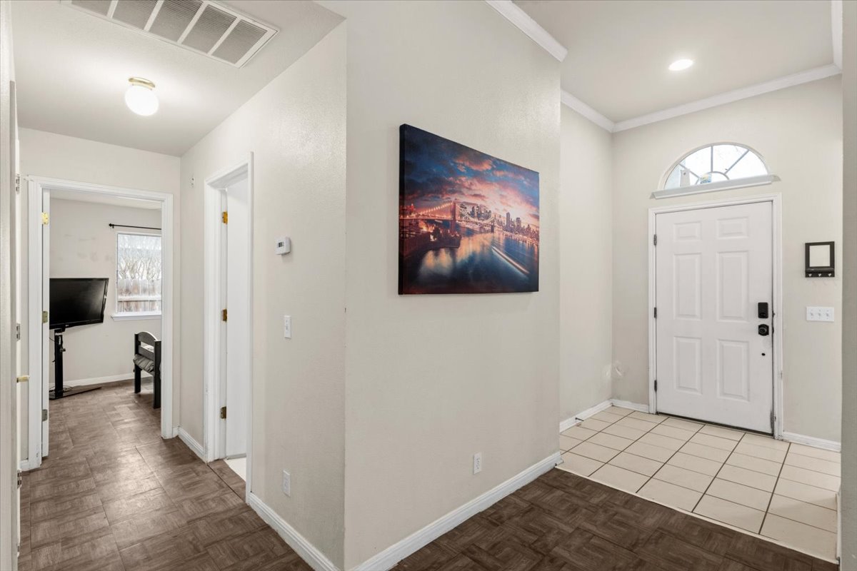 281 Leonardo Kyle, TX 78640 - Photo 4 of 38 a view of a hallway with wooden floor and a bathroom