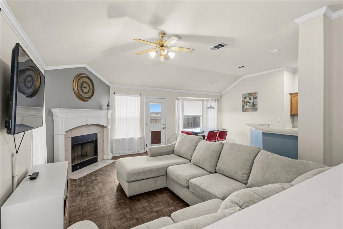 281 Leonardo Kyle, TX 78640 - Photo 5 of 38 a living room with furniture a clock and a fireplace