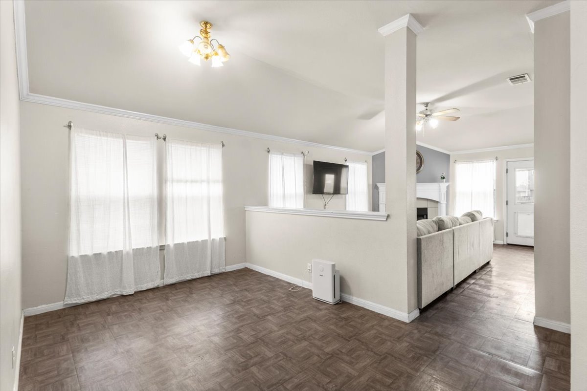 281 Leonardo Kyle, TX 78640 - Photo 7 of 38 a view of an empty room with a window and kitchen view