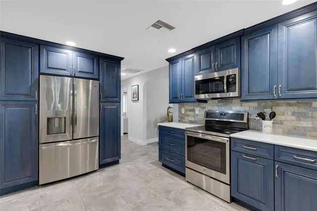a living room with furniture and a painting on the wall