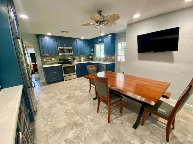 a kitchen with stainless steel appliances granite countertop a stove and a microwave