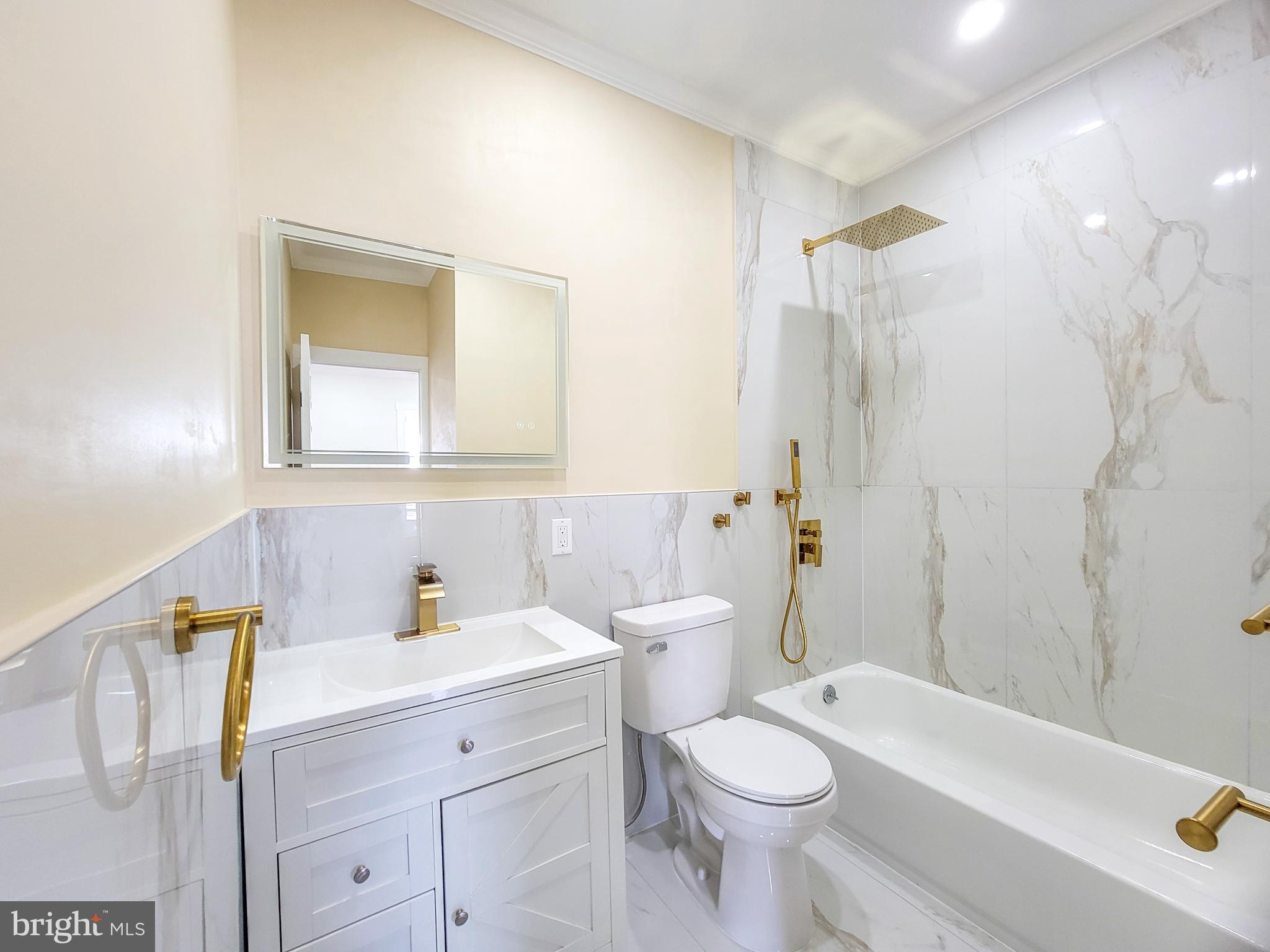 5502 Master Street Philadelphia, PA 19131 - Photo 12 of 63 a bathroom with a sink a toilet and shower