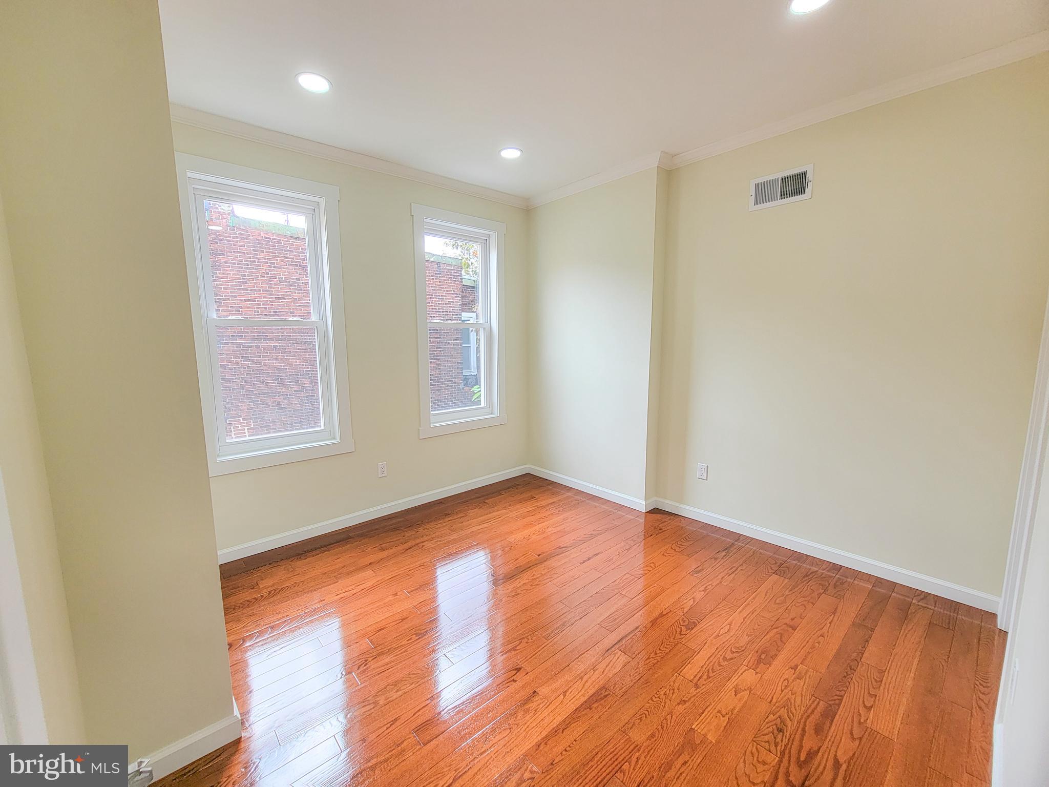 5502 Master Street Philadelphia, PA 19131 - Photo 14 of 63 a view of an empty room with wooden floor and a window