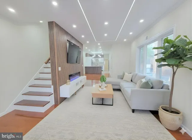 a view of a big room with wooden floor and windows