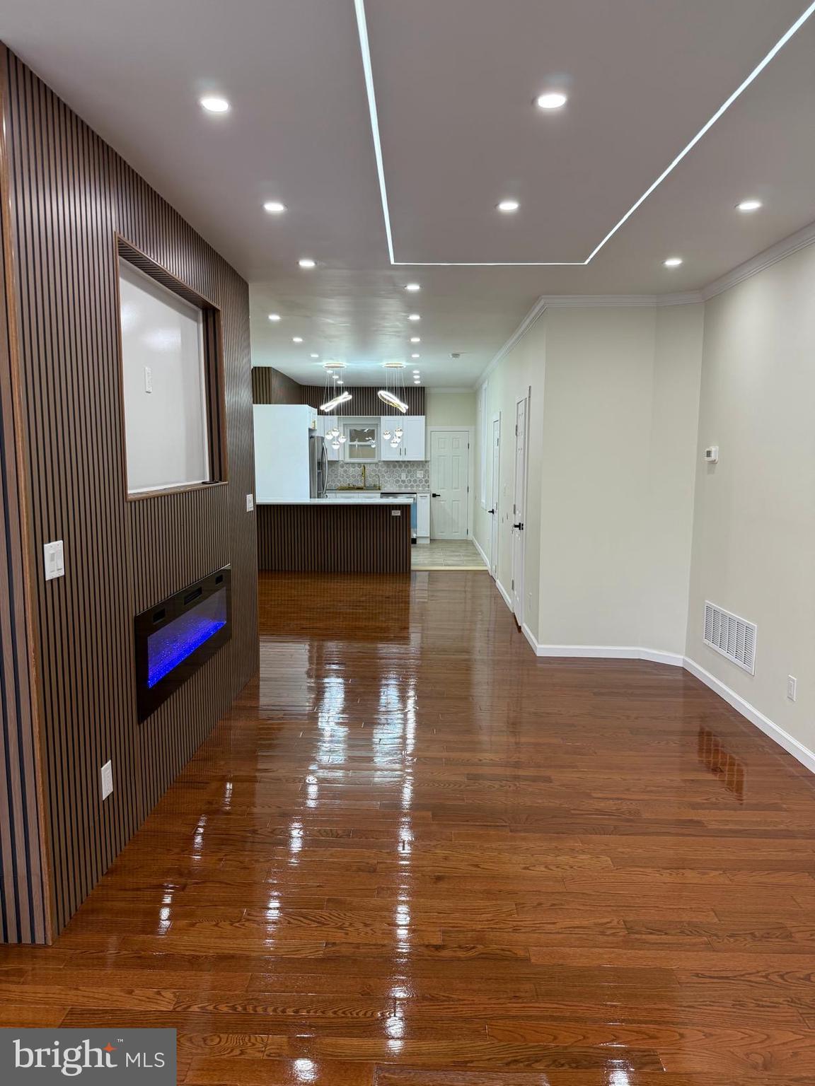 5502 Master Street Philadelphia, PA 19131 - Photo 25 of 63 a living room with kitchen view and a wooden floor