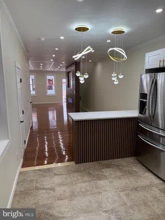 a white toilet sitting next to a white wall