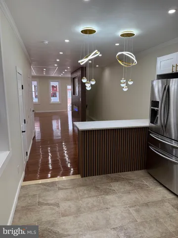 a white toilet sitting next to a white wall