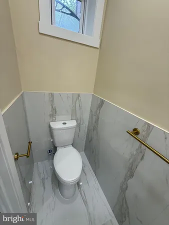 a utility room with a sink and mirror