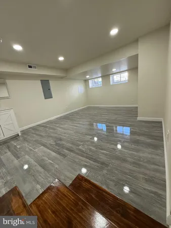 a view of an empty room and wooden floor