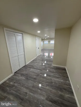 a view of a hallway with wooden floor and stairs