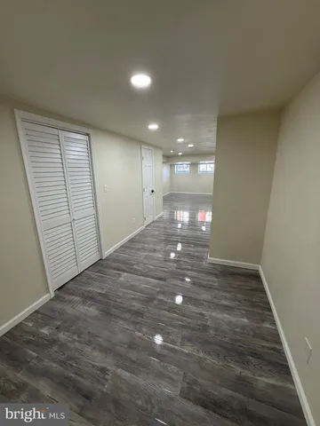 a view of a hallway with wooden floor and stairs