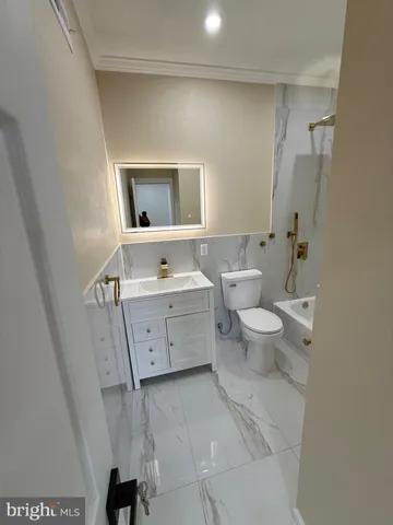 a hallway with wooden floor table and chairs