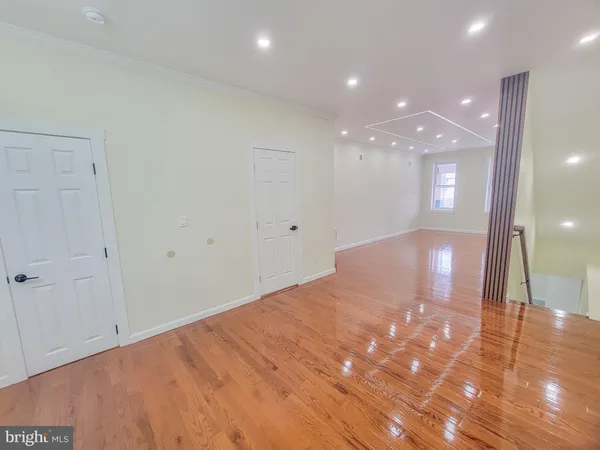 a bedroom with a large bed and a painting on the wall
