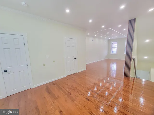 a bedroom with a large bed and a painting on the wall