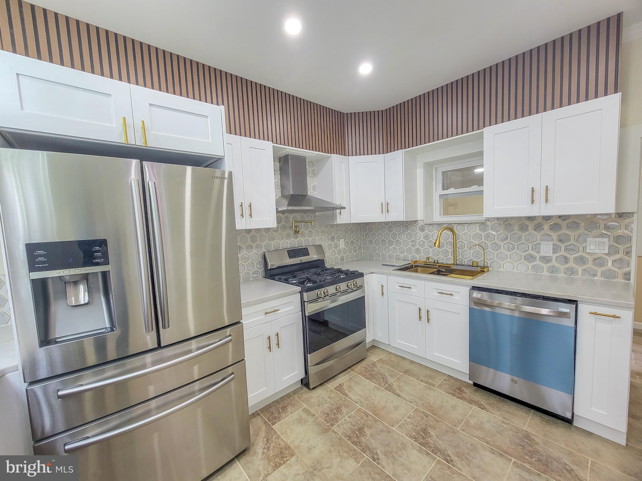 5502 Master Street Philadelphia, PA 19131 - Photo 7 of 63 a kitchen with stainless steel appliances granite countertop a refrigerator sink and cabinets