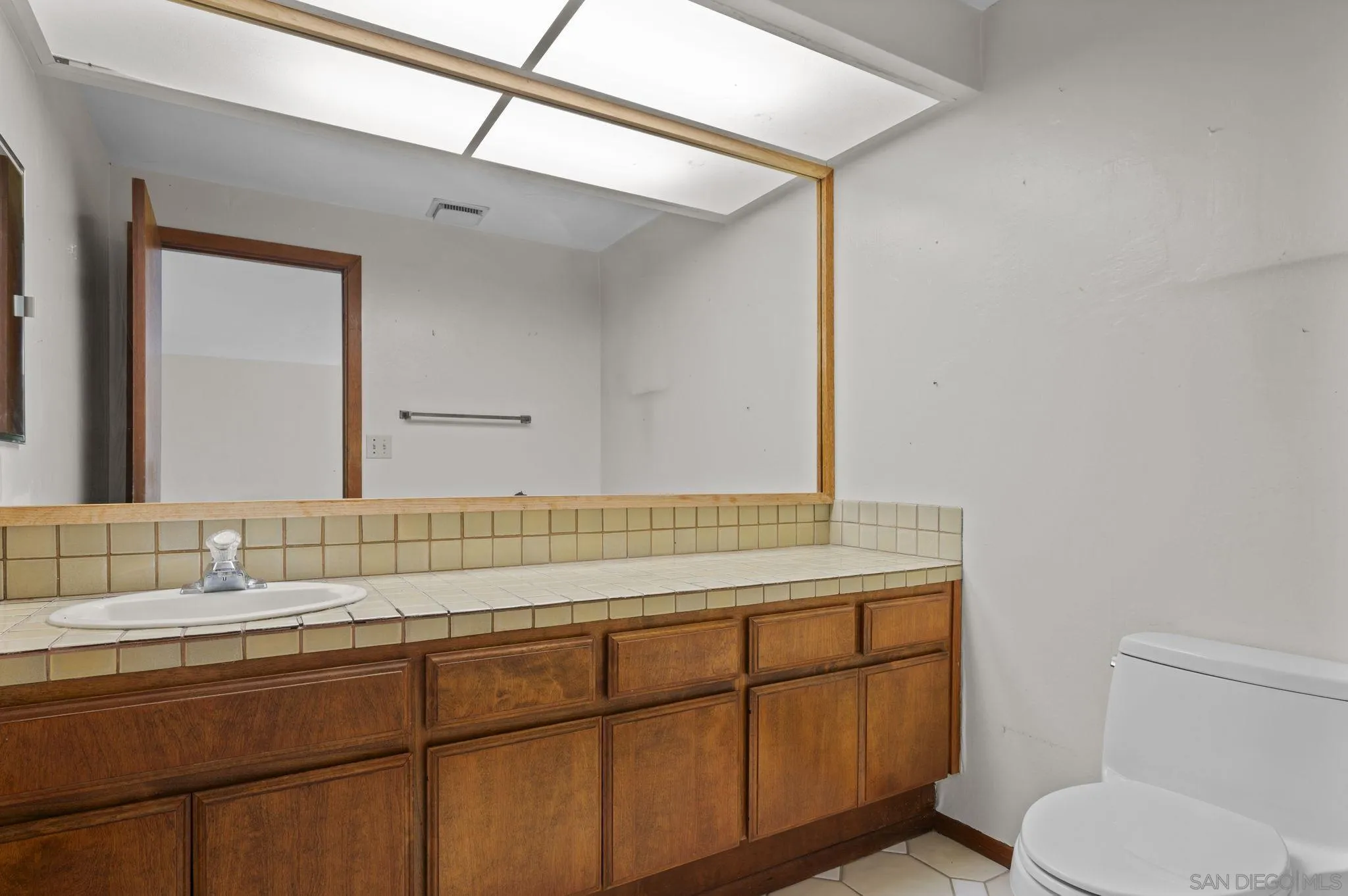 2029 Del Mar Heights Road Del Mar, CA 92014 - Photo 15 of 51 a bathroom with a sink toilet vanity and mirror