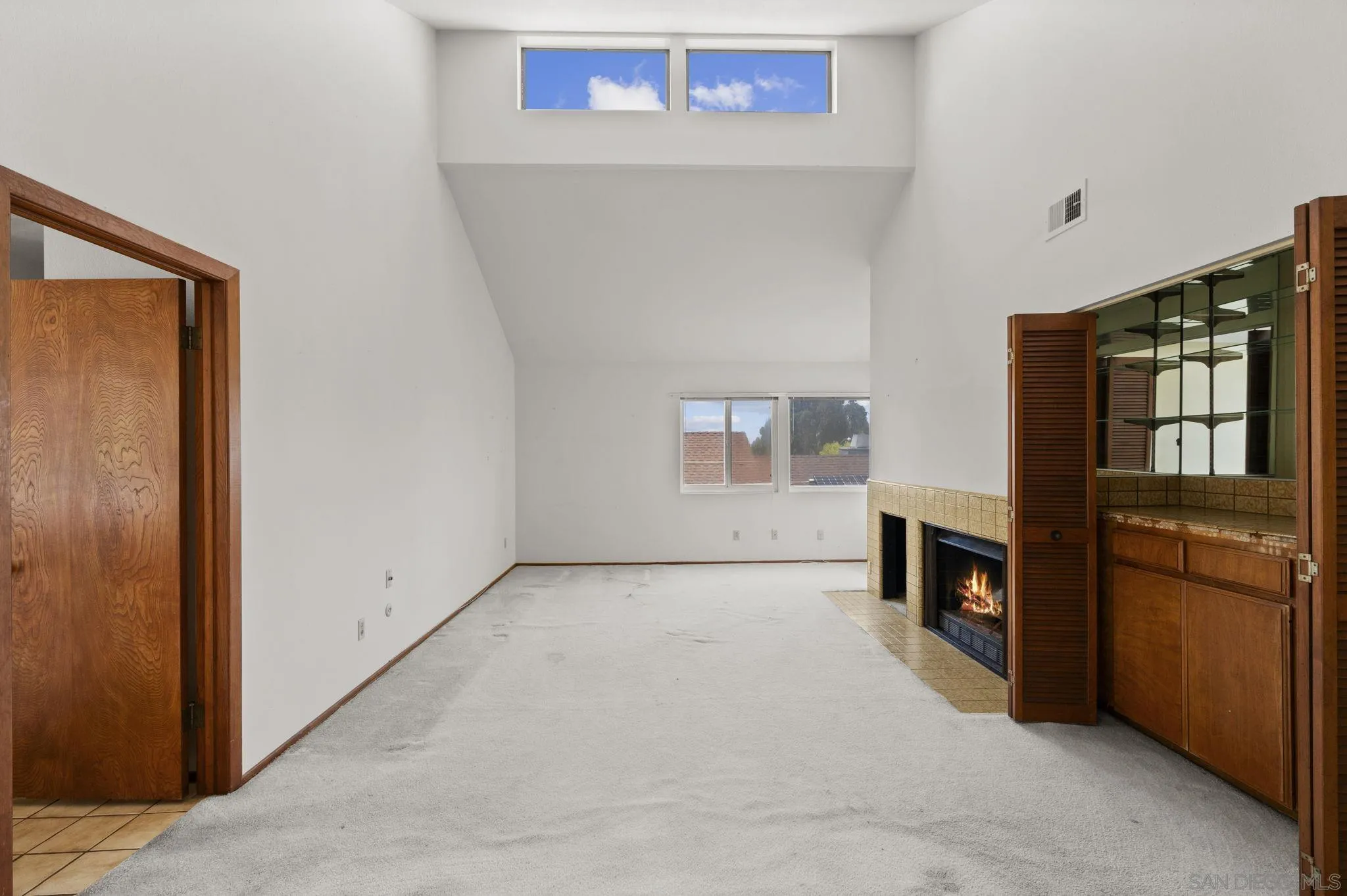 2029 Del Mar Heights Road Del Mar, CA 92014 - Photo 18 of 51 an empty room with fireplace and windows