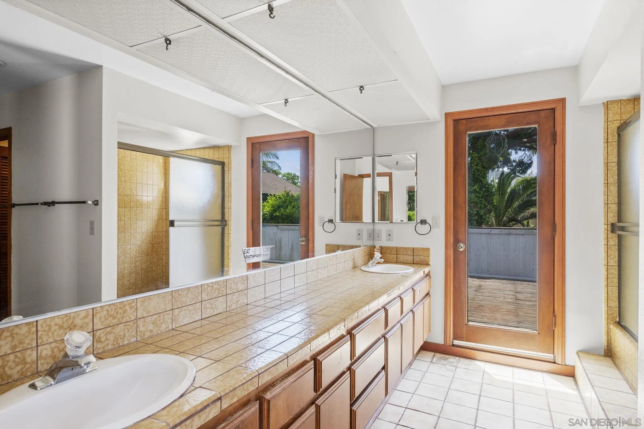 2029 Del Mar Heights Road Del Mar, CA 92014 - Photo 21 of 51 a bathroom with a granite countertop sink and a large mirror