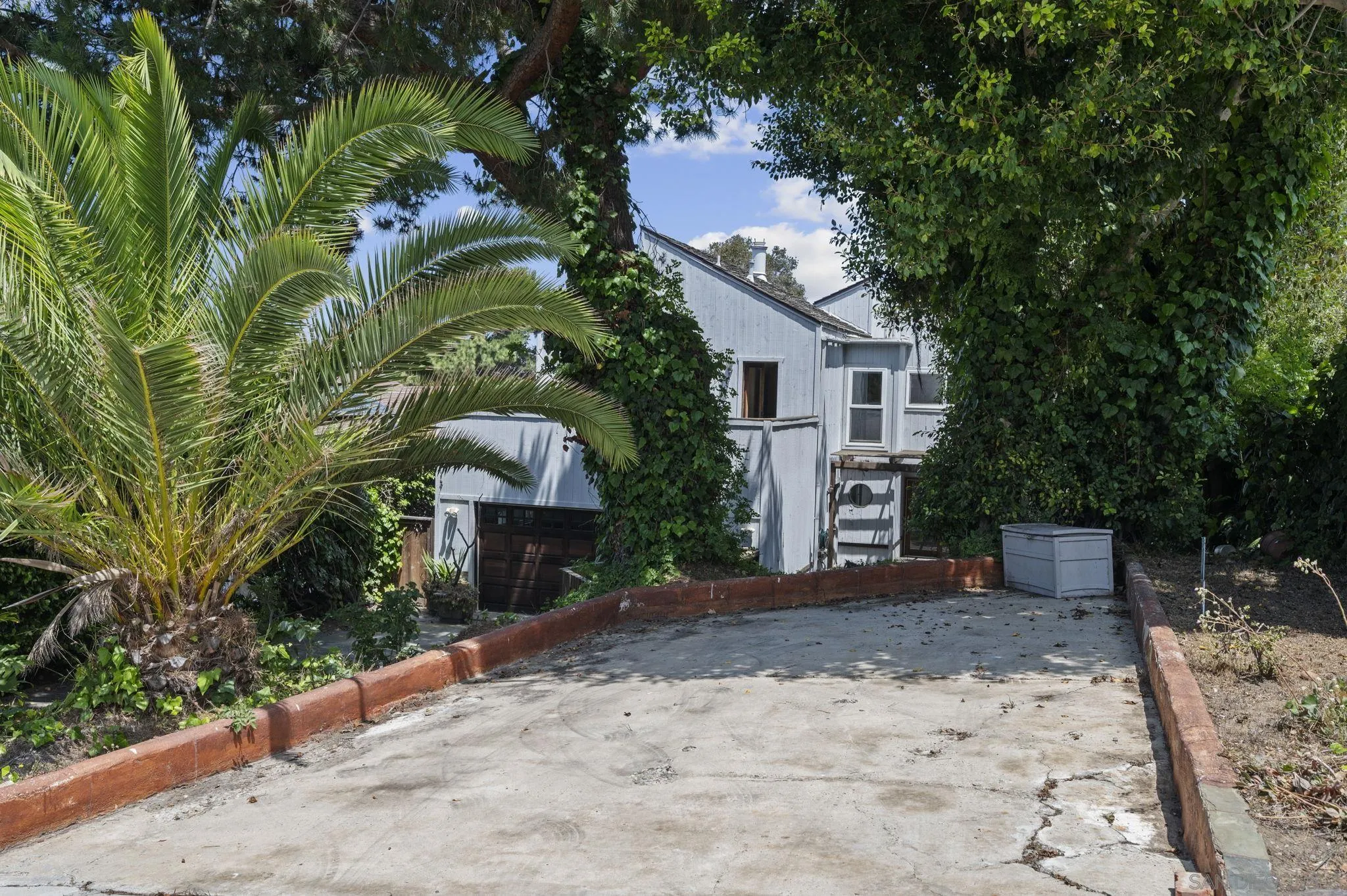 2029 Del Mar Heights Road Del Mar, CA 92014 - Photo 40 of 51 a front view of a house with a yard and garage