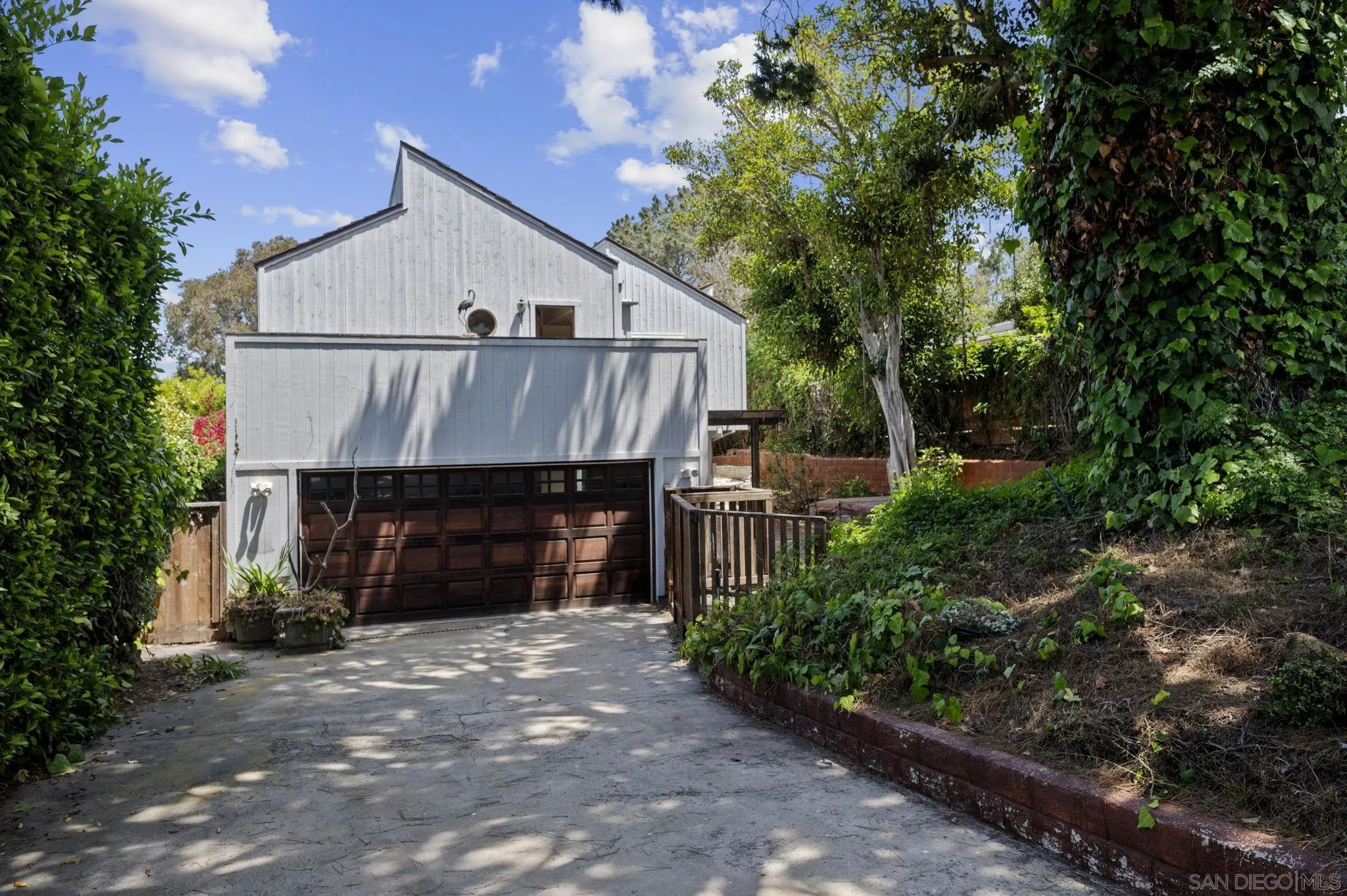 2029 Del Mar Heights Road Del Mar, CA 92014 - Photo 41 of 51 a front view of a house with a yard and garage