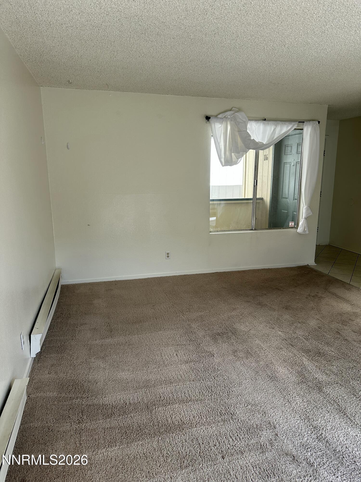 3928 Clear Acre Lane, Unit 116 Reno, NV 89512 - Photo 3 of 12 an empty room with a window
