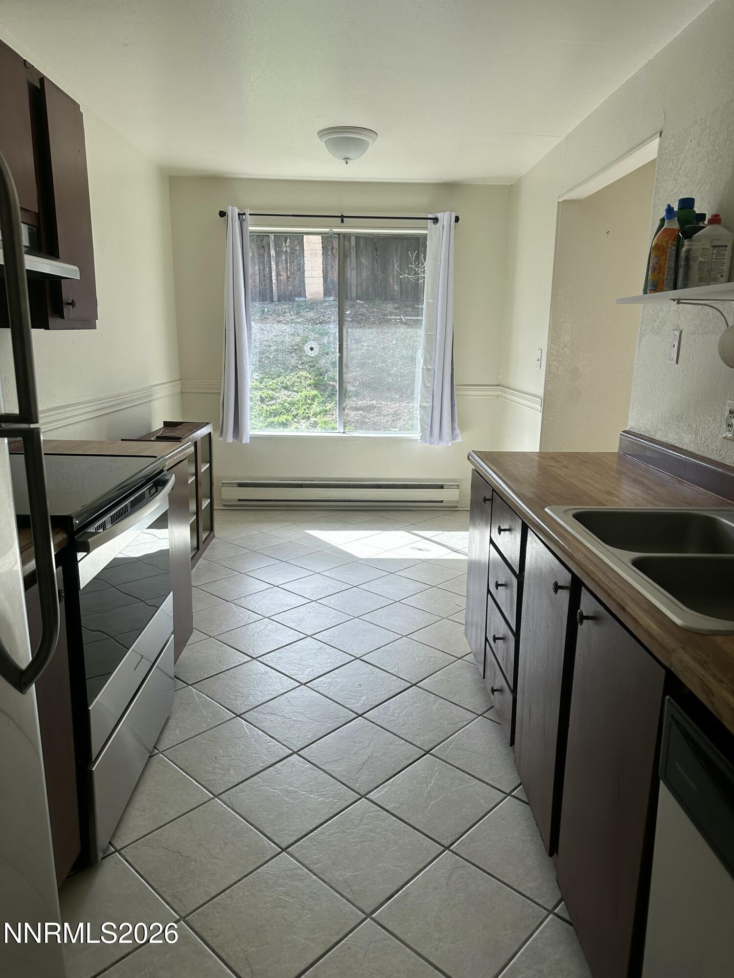 3928 Clear Acre Lane, Unit 116 Reno, NV 89512 - Photo 6 of 12 a kitchen that has a sink and a stove