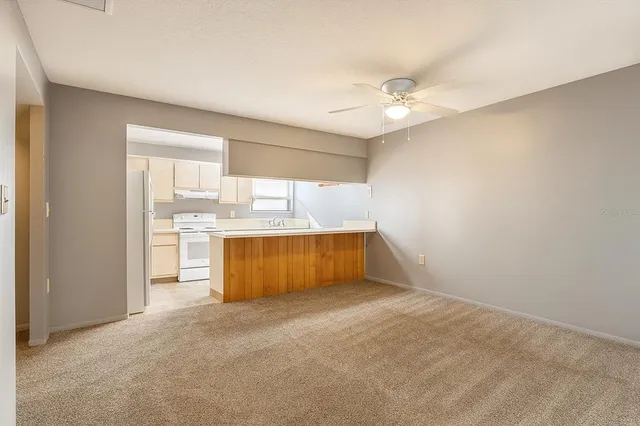 a view of a kitchen with wooden cabinet and a refrigerator