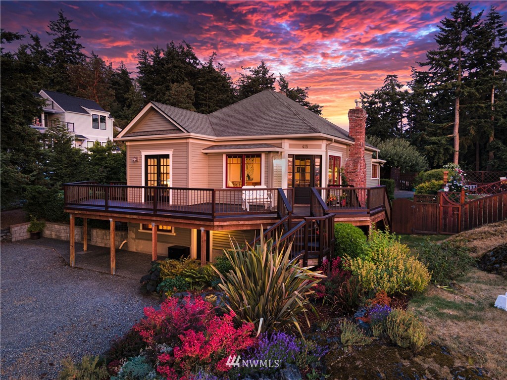 a front view of a house with a yard and balcony