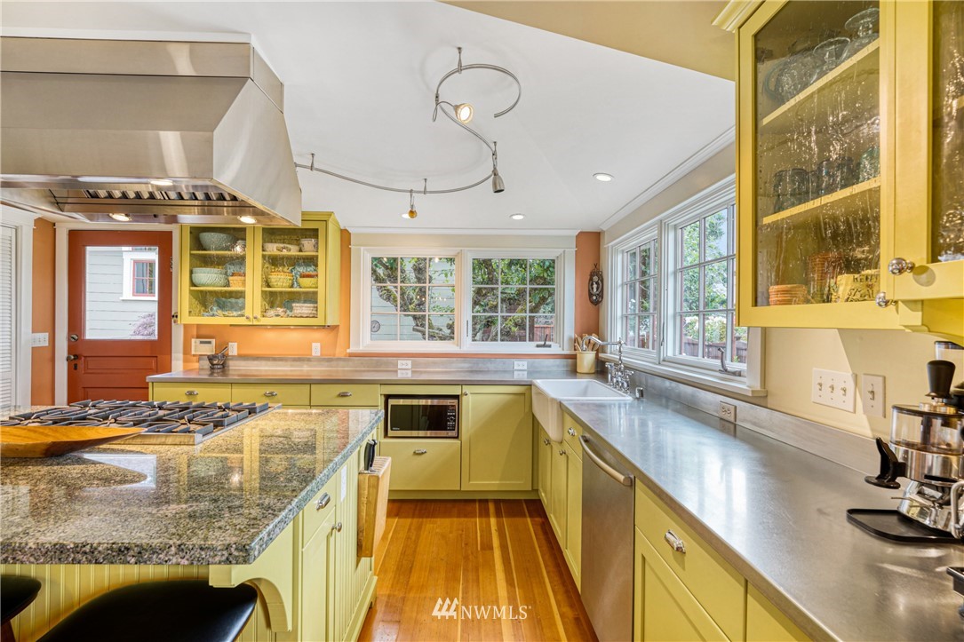 415 5th Street Anacortes, WA 98221 - Photo 11 of 38 a kitchen with a sink stove and cabinets