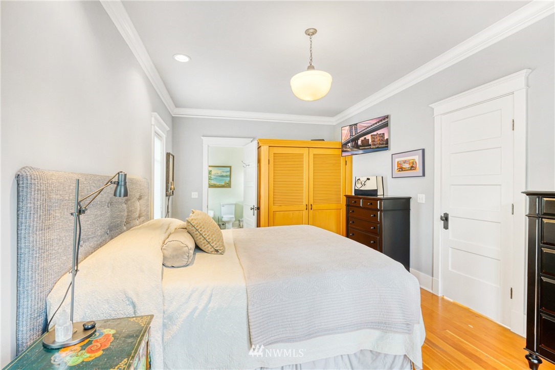 415 5th Street Anacortes, WA 98221 - Photo 15 of 38 a bedroom with a bed and wooden floor