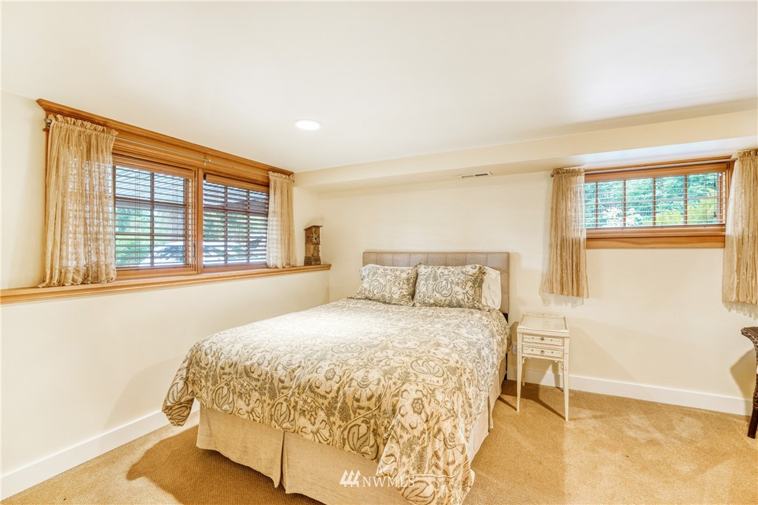 415 5th Street Anacortes, WA 98221 - Photo 24 of 38 a bedroom with a bed and a large window