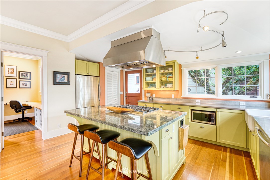 415 5th Street Anacortes, WA 98221 - Photo 9 of 38 a kitchen that has a stove and a table in it