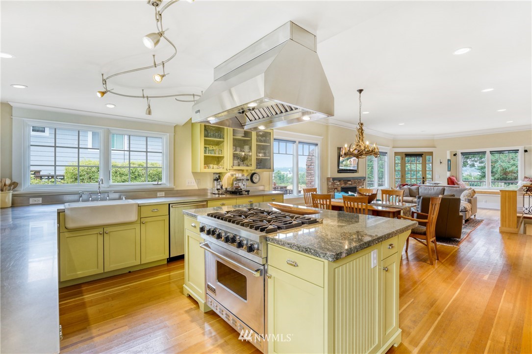 415 5th Street Anacortes, WA 98221 - Photo 10 of 38 a kitchen with stainless steel appliances granite countertop a stove and a view of living room