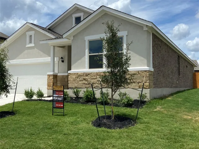 a view of a house with a backyard