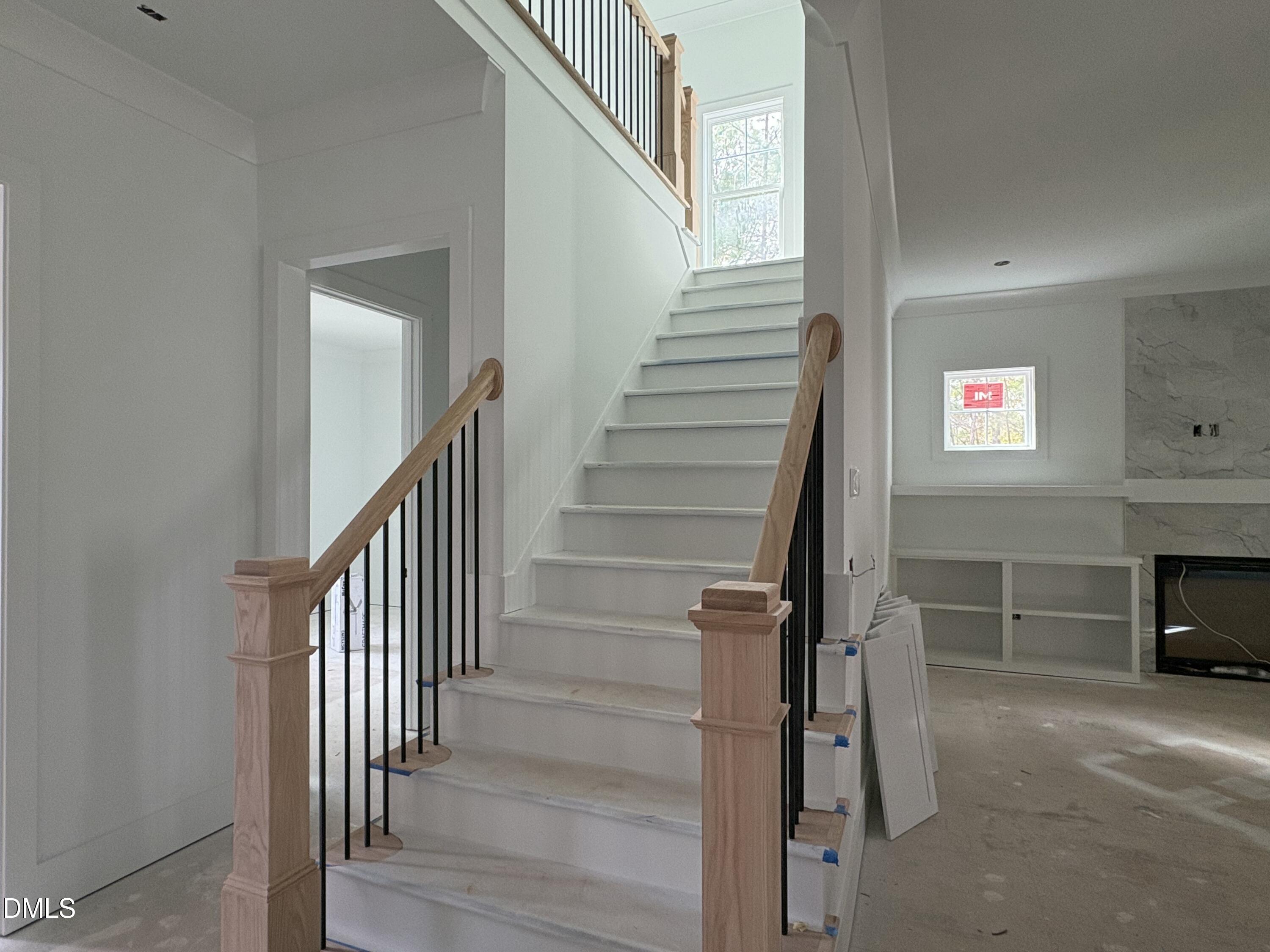 191 High Ridge Lane Pittsboro, NC 27312 - Photo 6 of 54 a view of a hallway with stairs and a fireplace